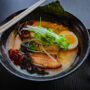 ramen in bowl with chopsticks and spoon
